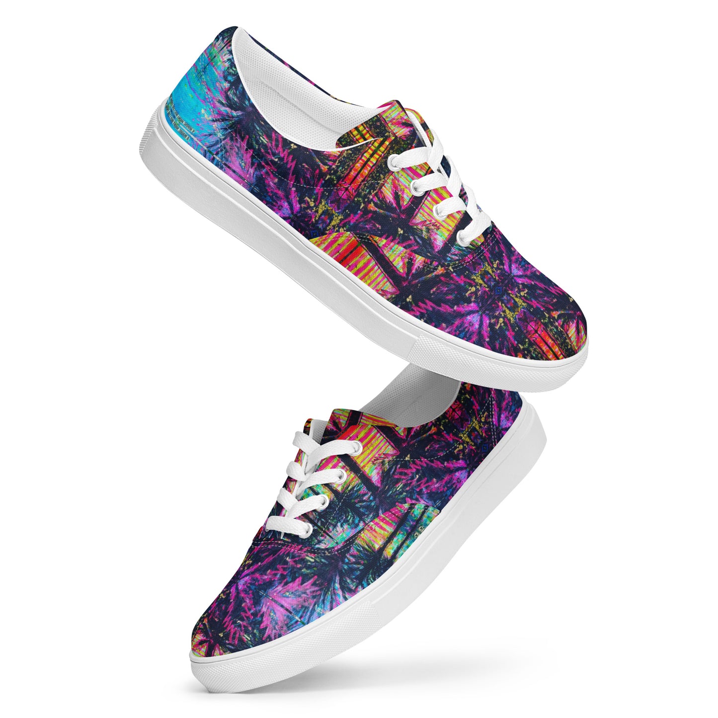 Angled view of white lace-up canvas shoes displaying the full multicolour Barcelona artwork pattern