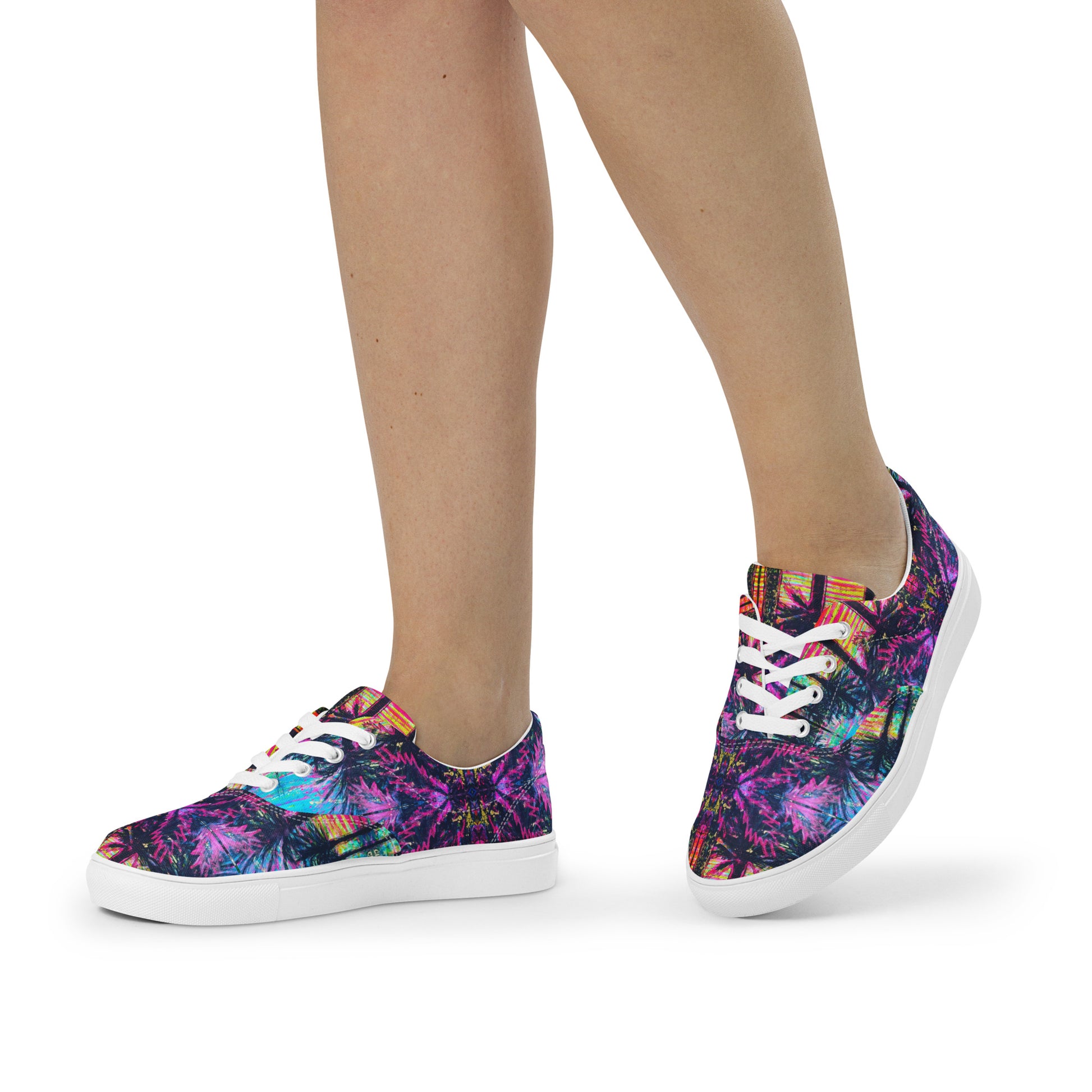 Side view of white canvas lace-up shoes showing the vibrant Barcelona graphic print design while being worn