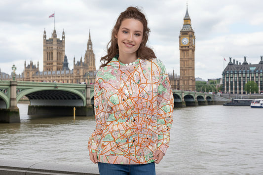 Woman wearing a colorful map-patterned hoody by the River Thames