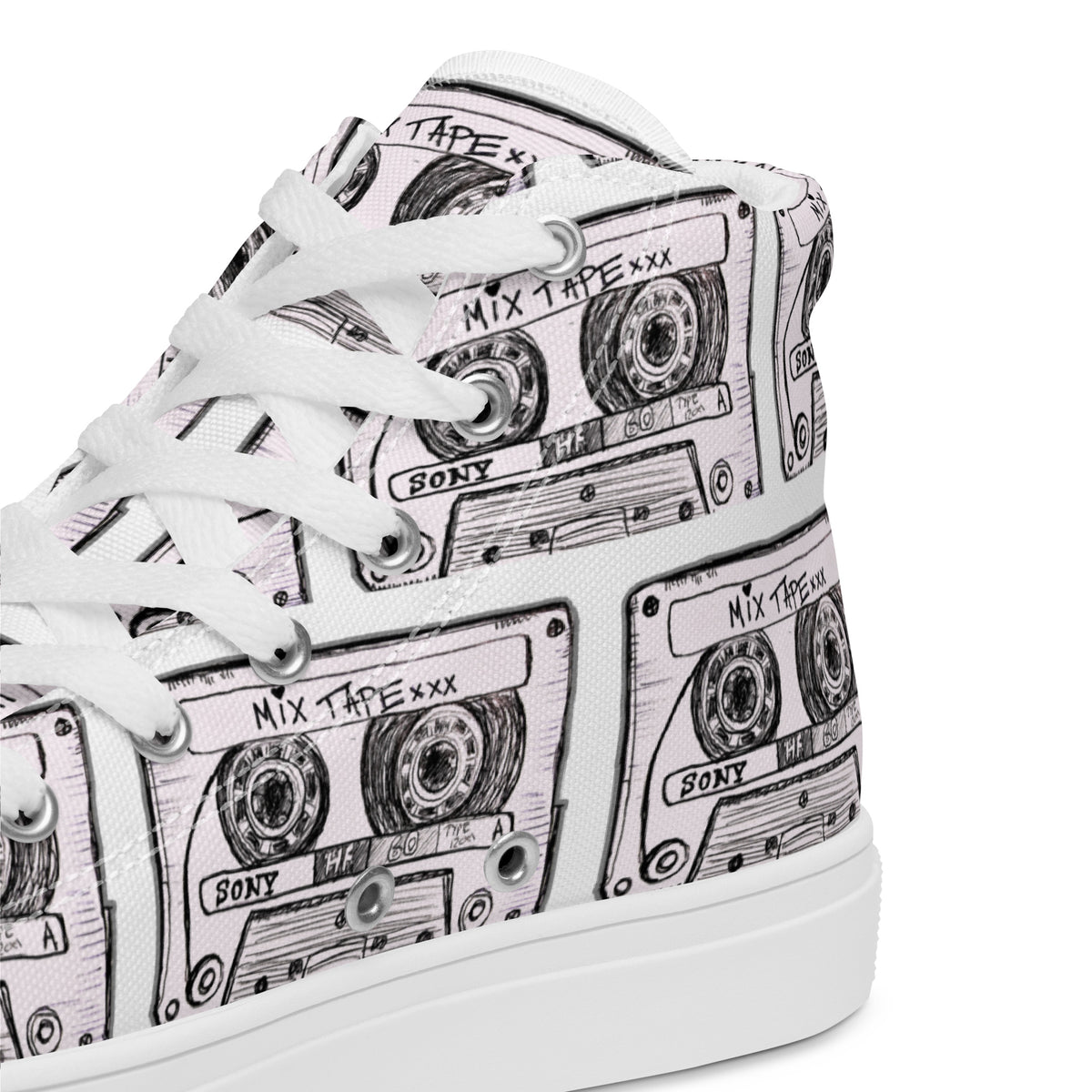 Close Up of Vicky Steane's Mix Tape White high-top sneaker with a black and light pink cassette tape print, featuring white laces and a white rubber sole.