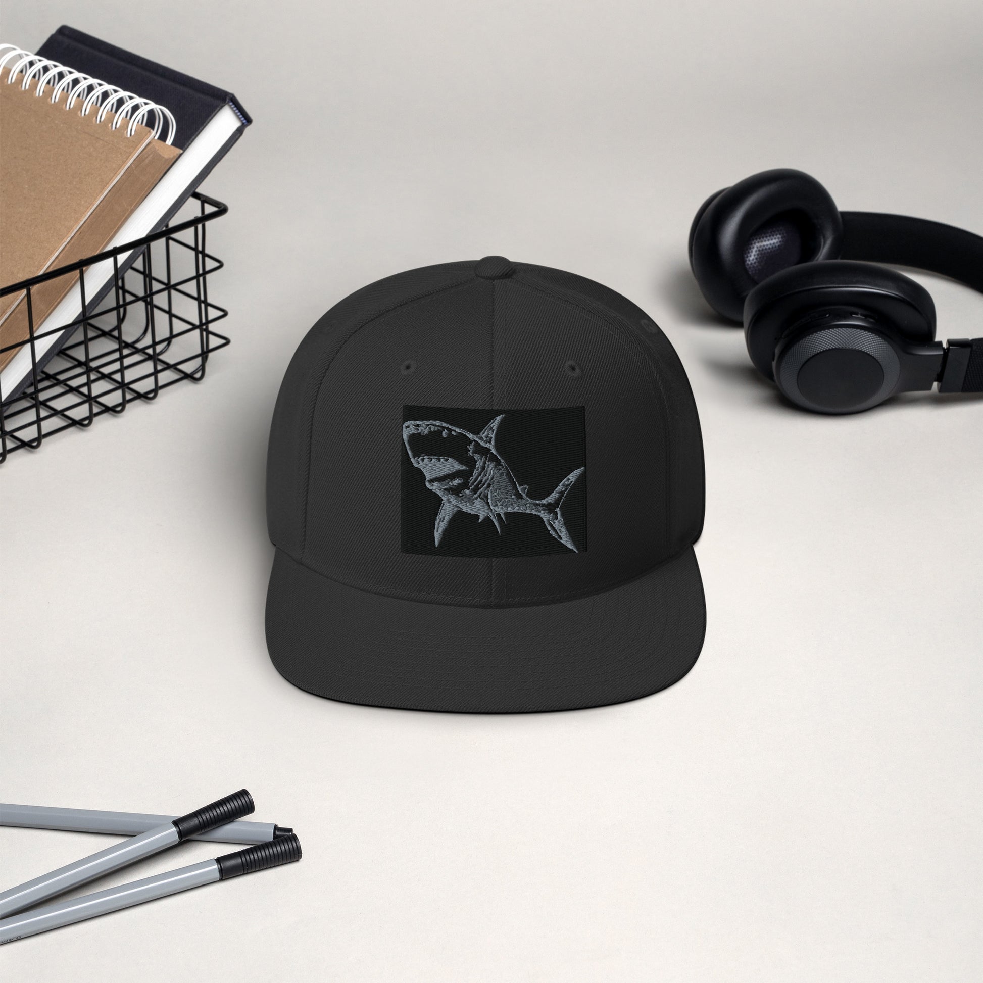 dark navy Shark Attack snapback hat with bold shark artwork by Vicky Steane, close-up detail